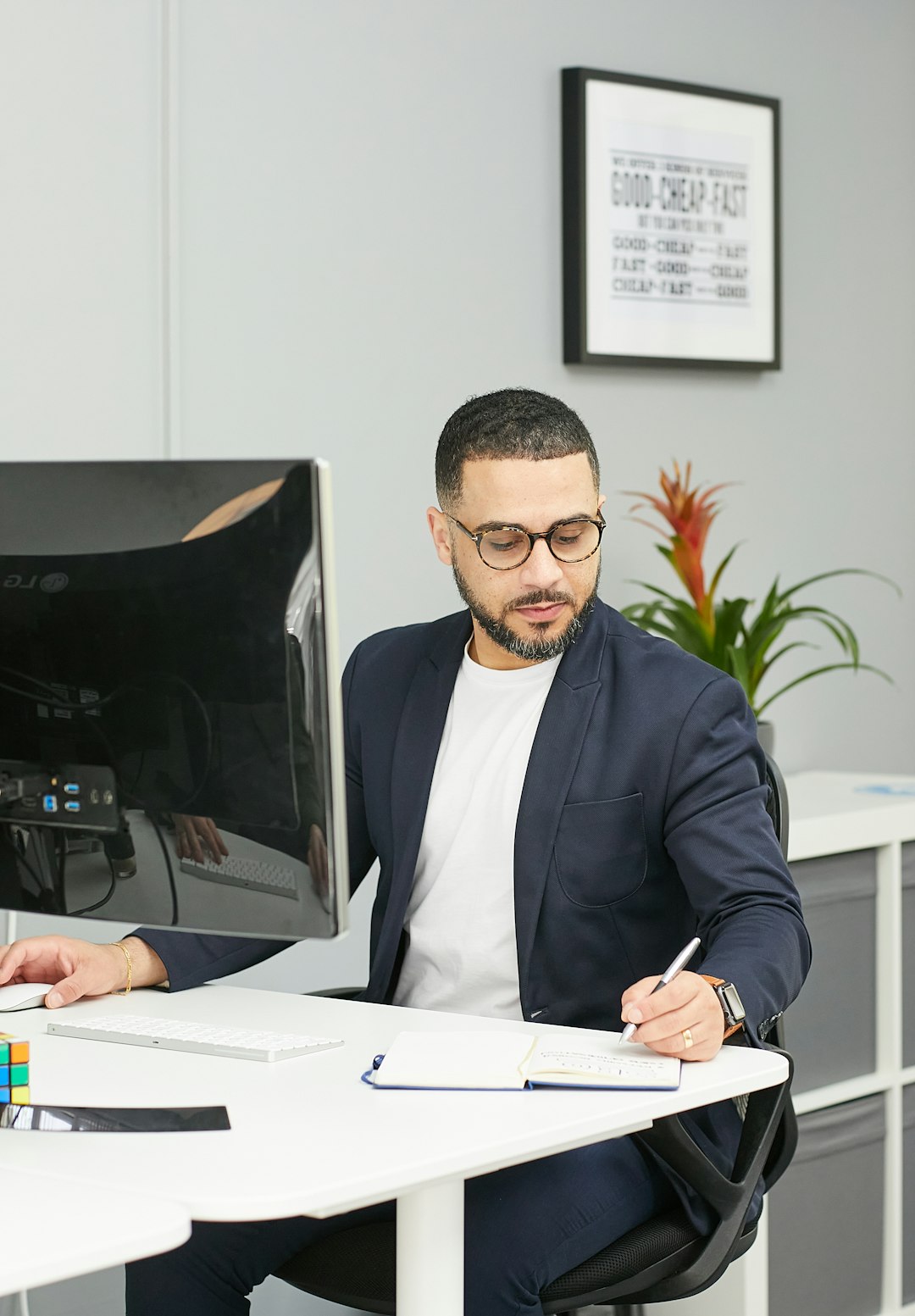 a-man-sitting-at-a-desk-n4ak7vy1mcm